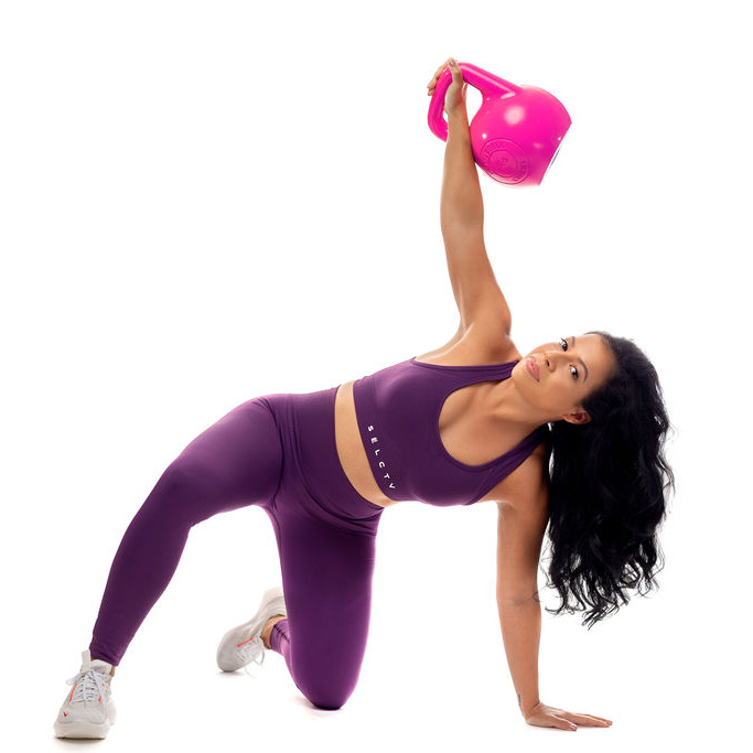 Ana holding pink kettlebell up