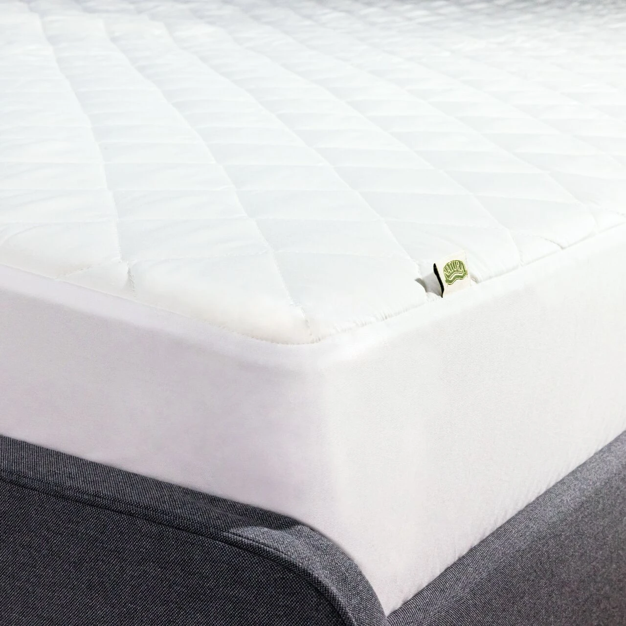 Natura Smart Wash Wool™ Luxury Wool Filled Mattress Pad Protector, Corner Tag Natura On Mattress
