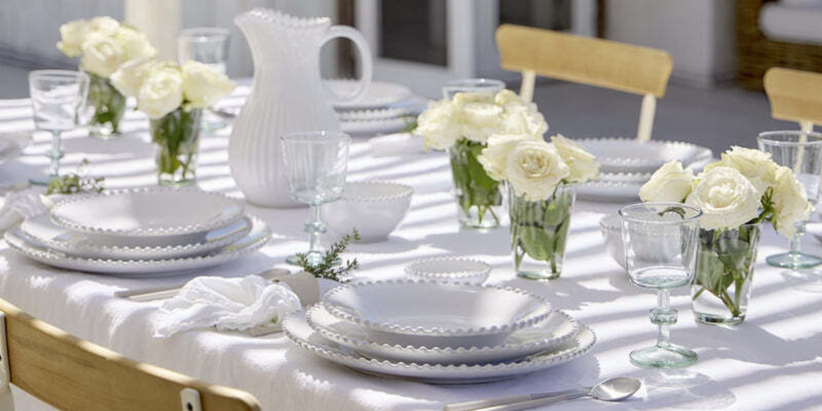 Costa Nova Pearl white dinnerware arranged on an elegant table