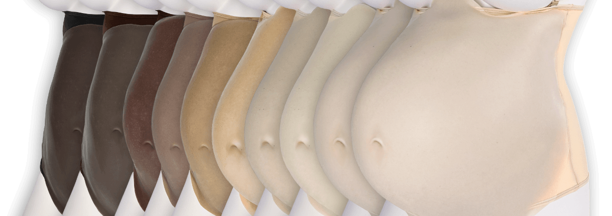 An array of fake pregnant bellies showing ten inclusive skin tone shades from fair to dark