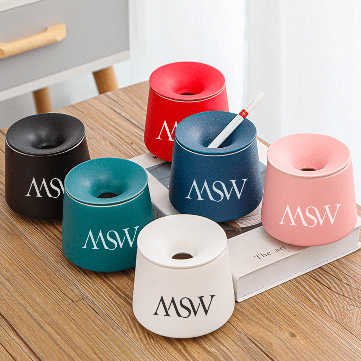 A ceramic ashtray with a lid and a custom logo