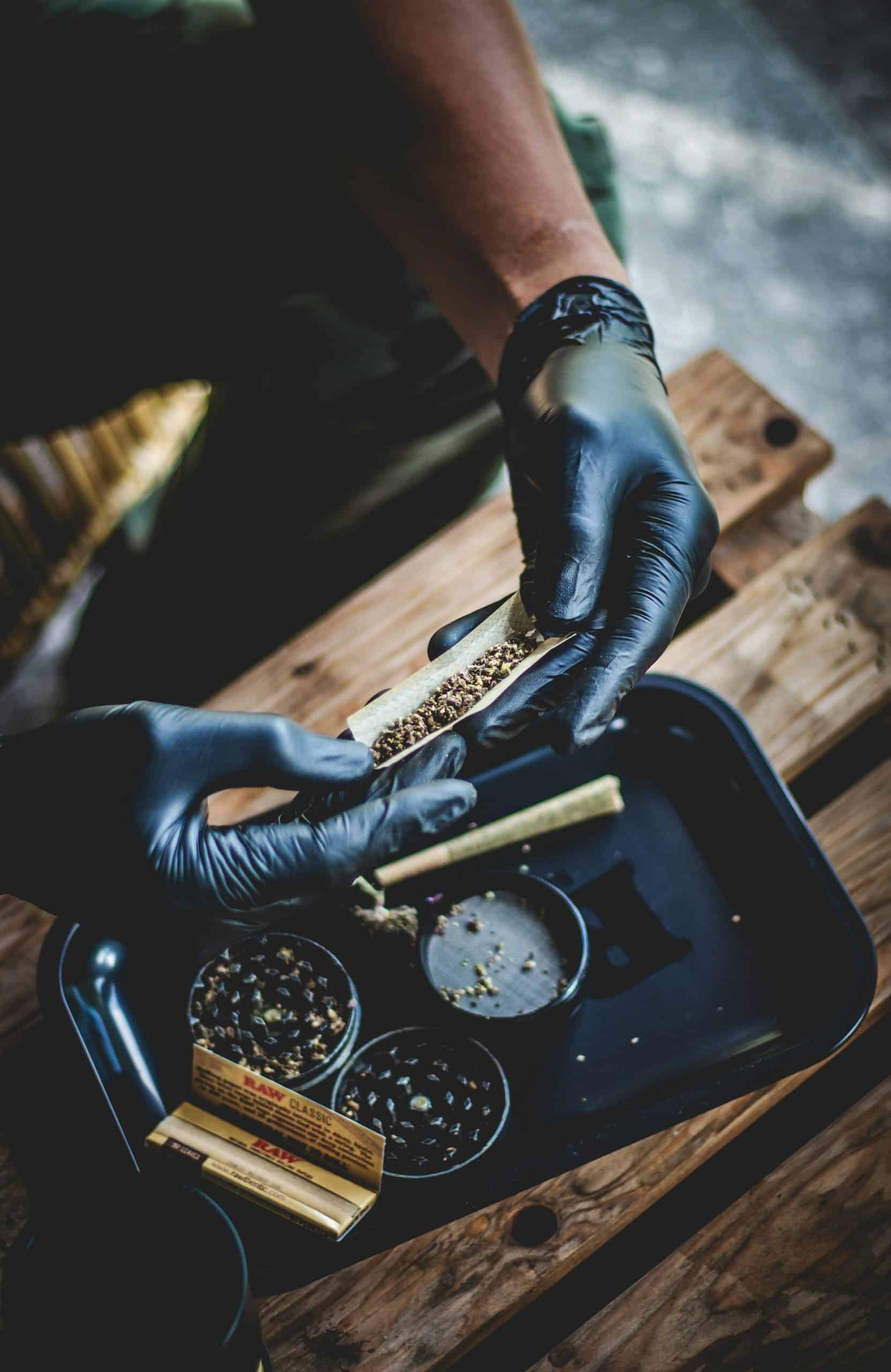 A person using a rolling tray to prepare a roll.