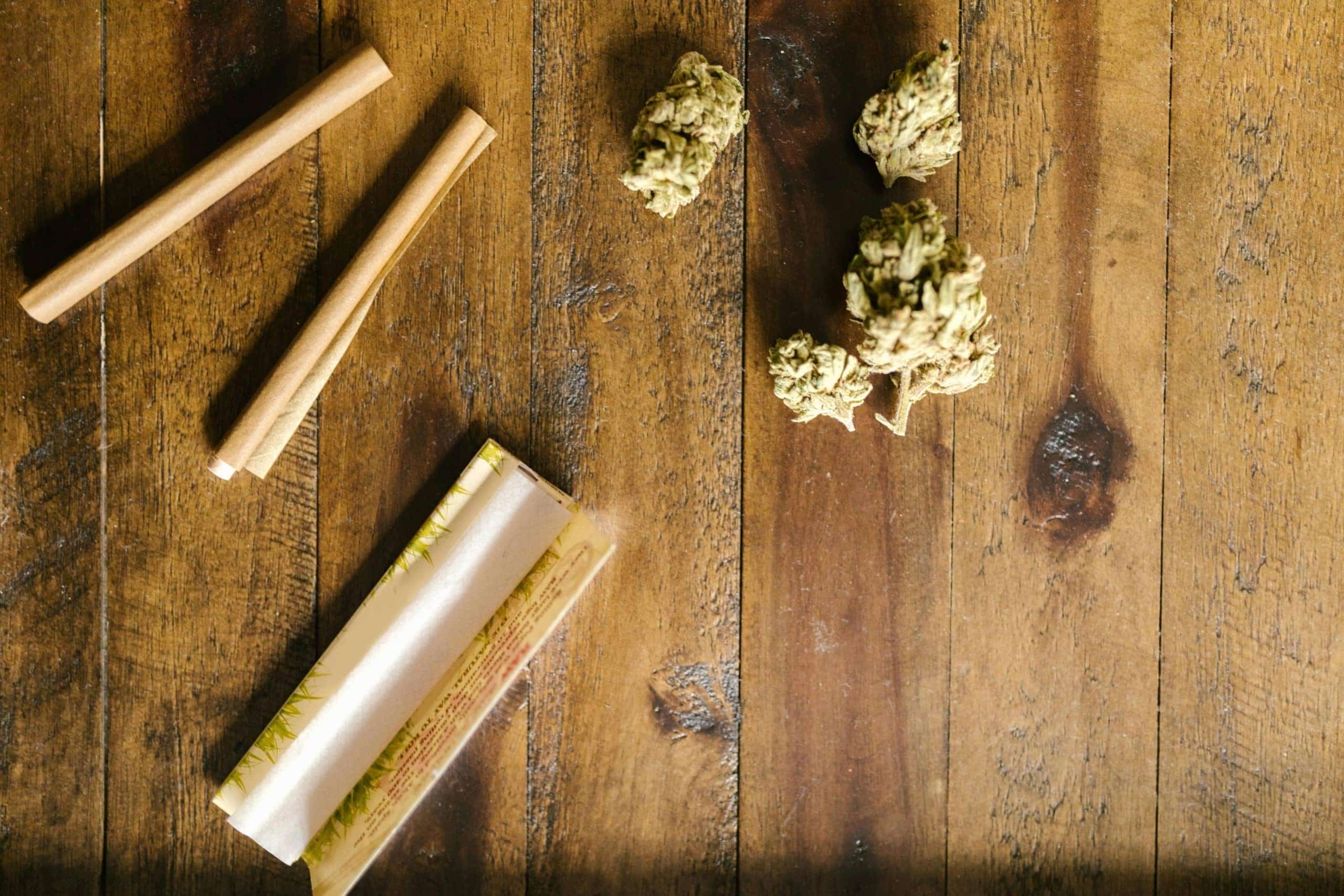 A pack of RAW rolling papers with a hand-rolled cigarette.
