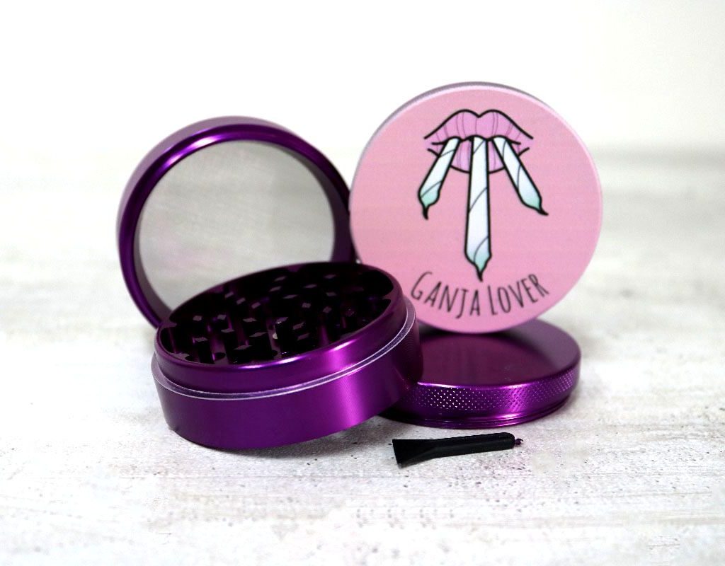 The 4-piece aluminum grinder opened to show its sharp teeth and compartments.