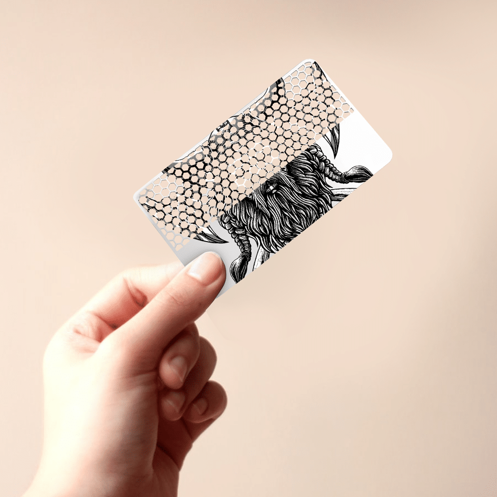 A custom grinder card with a whimsical creature and honeycomb pattern.