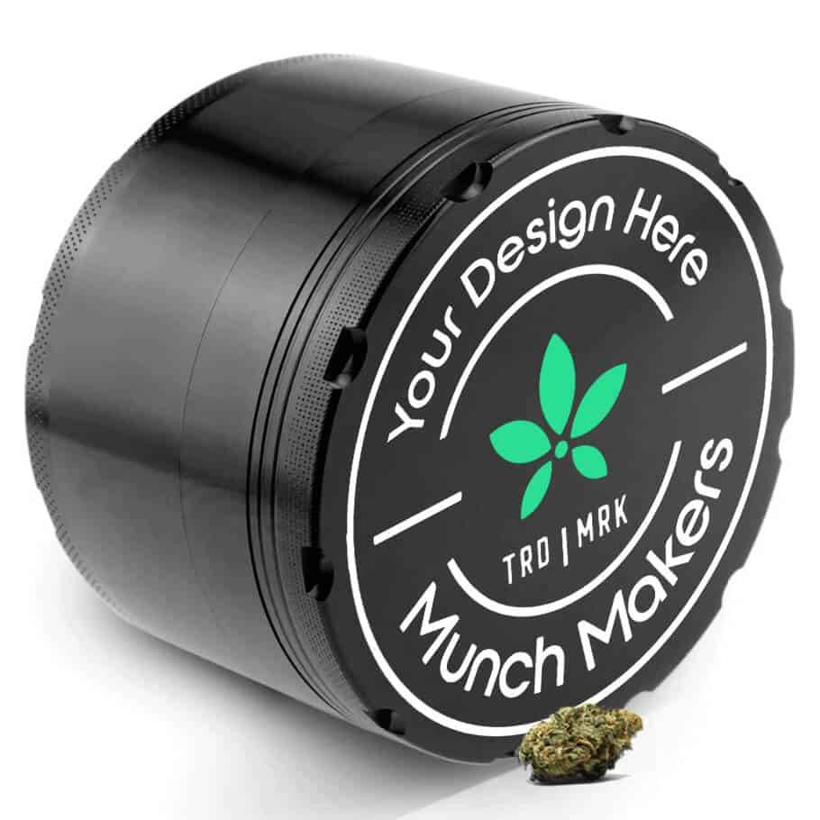 Silver PhatBoy XL large herb grinder next to several smaller grinders.