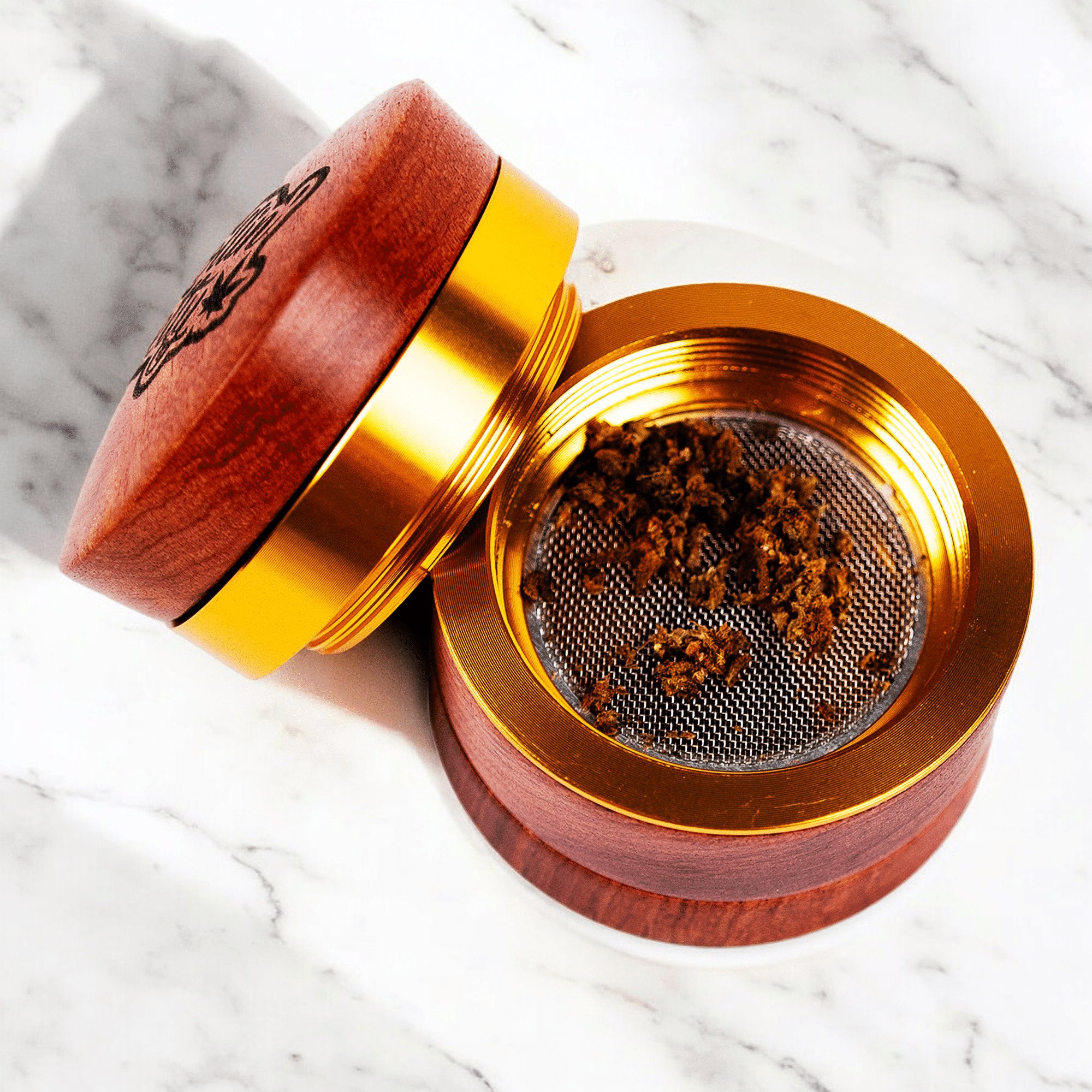 A custom genuine wood grinder with a logo engraved on top.