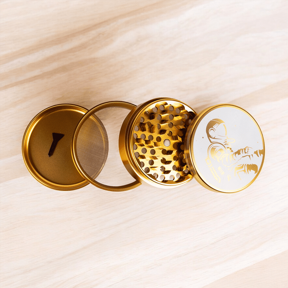 A stylish, large gold herb grinder shown from the side.