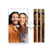 side-by-side comparison showing a full-color photo of a smiling couple on the left. An arrow points to the right, where the same photo is shown printed across three vertical, textured tubes, demonstrating a custom photo printing service.