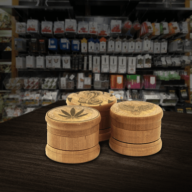 Engraved wooden grinder showing natural grain and custom logo
