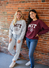 Classic MIT crest crewneck sweatshirt bold collegiate lettering and the official MIT seal. Available in sport grey or maroon for timeless campus style.