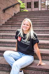 Black Champion Berklee College of Music t-shirt with red Berklee logo graphic and collegiate text design.