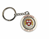 Harvard spinner keychain featuring rotating crest medallion and "Harvard Est.1636" engraving on white background.