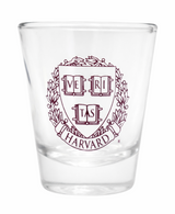 Harvard shot glass featuring the iconic Veritas crest in maroon on clear glass. A timeless gift or souvenir for Harvard alumni and fans.
