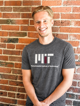 Officially licensed MIT Logo Gildan® Charcoal Heather T-shirt featuring the Massachusetts Institute of Technology logo. Soft cotton blend tee available in adult sizes S–2X.