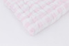 A light pink gingham/buffalo check cotton fabric.