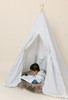 This tent is a black ticking material on white canvas fabric all around. The doors have white pom pom trim.
