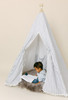 This tent is a black ticking material on white canvas fabric all around. The doors have white pom pom trim.