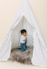 This tent is a black ticking material on white canvas fabric all around. The doors have white pom pom trim.