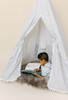 This tent is a black ticking material on white canvas fabric all around. The doors have white pom pom trim.