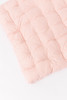 A pink cotton fabric with red Swiss dots.