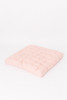 A pink cotton fabric with red Swiss dots.