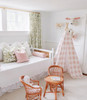 A dark blush pink gingham/buffalo plaid play tent.