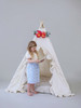 The Joanna tent is made from natural twill cotton with vertical ruffles on the front doors.