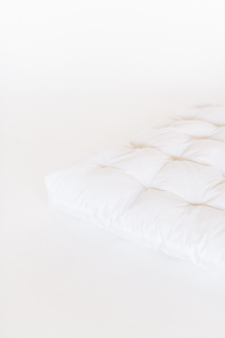 All white twill cotton play mattress handtufted with premium polyester fiberfill.