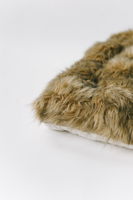 A fox brown faux fur playmat.