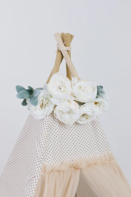 The Toria Play Tent by E&E is a unique tent with gorgeous tulle doors!! Tulle is four layers thick! The rest of the tent is a cream fabric with black Swiss dots made up of 100% pima cotton. It has four wooden poplar rods that hold up a beautifully crafted tent.