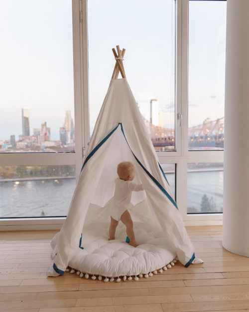 The Tyler Play Tent is very neutral but ready for adventure. This all white play tent is made from 100% premium cotton (OEKO-TEX certified) and denim blue colored binding. The play tent comes with tie back doors. It has four wooden poplar rods that hold up a beautifully crafted play tent.