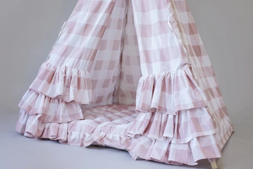 The Bonnie Play Tent is a dark blush pink gingham/buffalo plaid play tent with 3 sets of horizontal ruffles