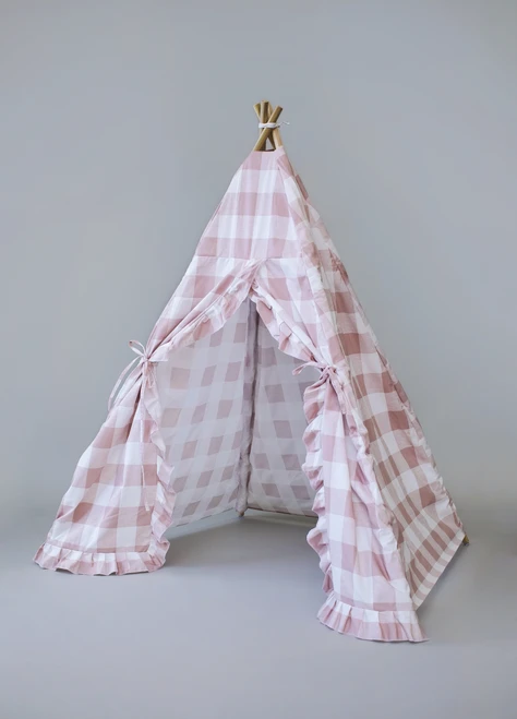 The Brandy Play Tent is a dark blush pink gingham/buffalo plaid play tent with vertical ruffles along the front panels.