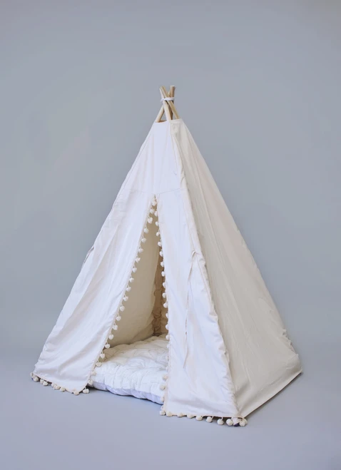 The Adrian tent is made from natural twill cotton with cream pom poms on the front panels.