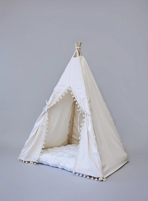 The Adrian tent is made from natural twill cotton with cream pom poms on the front panels.