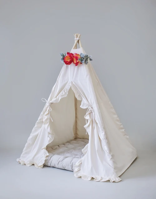 The Joanna tent is made from natural twill cotton with vertical ruffles on the front doors.