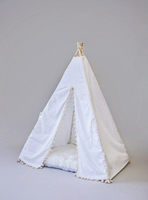 The Skylar tent is made from white twill cotton with cream pom poms on the front panels.