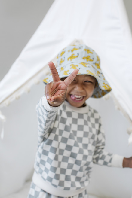 The Skylar tent is made from white twill cotton with cream pom poms on the front panels.