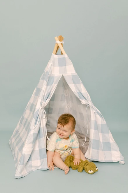 This tent is all blue gingham fabric pattern made of 100% 7 oz. cotton fabric. It has four wooden poplar rods that hold up a beautifully crafted tent.