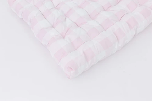 A light pink gingham/buffalo check cotton fabric.