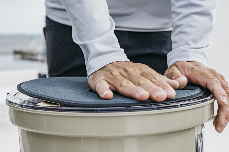 Person installing SeaDek cooler pad on Yeti cooler