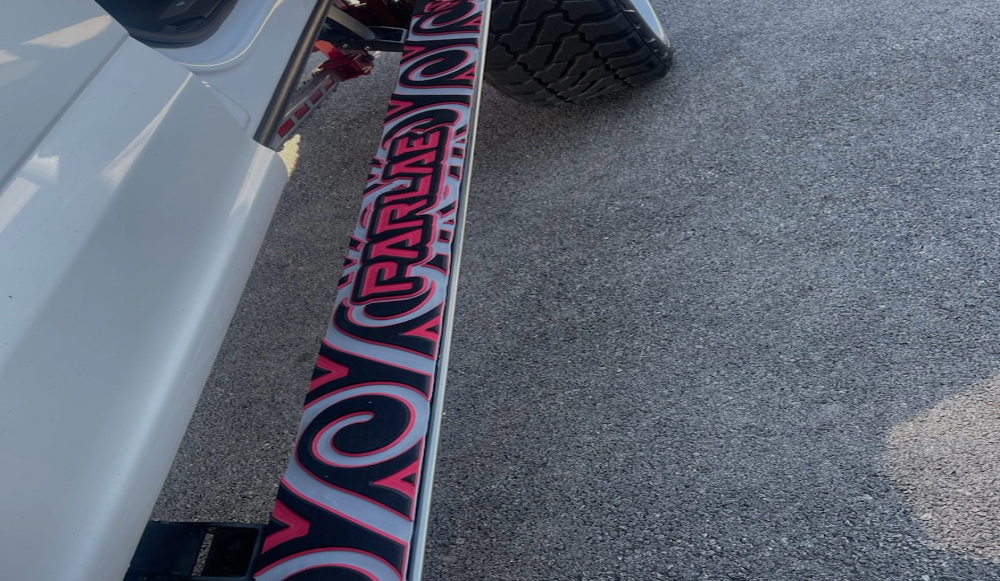 Truck step running board with custom SeaSek black over red over white colors and pattern design