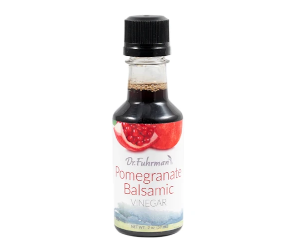 Dr. Fuhrman Pomegranate Balsamic Vinegar in a 2 oz sampler-size bottle with a label showing a cut pomegranate.