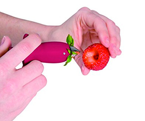 Strawberry huller pulling the stem and core out of a strawberry, leaving a neat hollow.