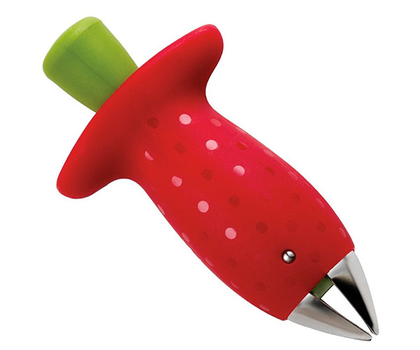 Strawberry huller shaped like a red strawberry, with a green push button on top and a stainless steel claw at the tip.