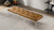 Caldwell 60" Genuine Tan Leather Tufted Bench with Metal Cross Base