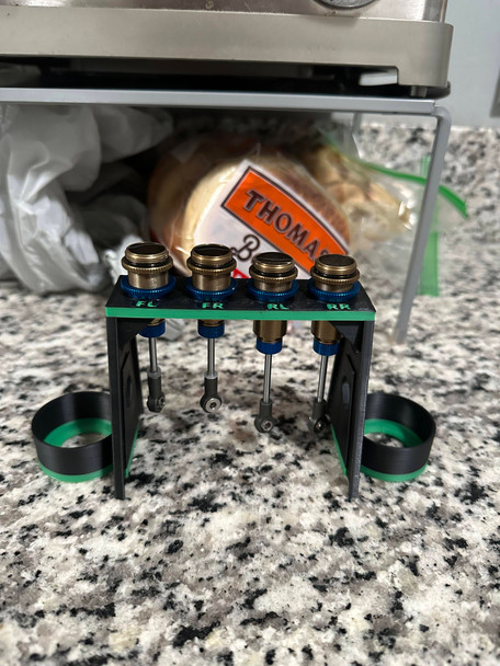 <p>This Shock Stand helps to keep shock maintenance clean & organized on an otherwise messy job. 4 Main slots for holding shocks and 2 side-by-side inserts for holding shock oil. Designed for standard 12mm shocks, i.e. Team Associated B6/B6D, B64/B64D, Losi 22 etc. The holes are slightly bigger than 14mm, which fits most of these shocks snugly. If you want to track the original position of each shock, each hole is labeled for front/rear/left/right.</p><p>*Package Includes*<br>x1 1/10th Scale Shock Holder<br></p>