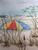 Three beach umbrellas painting by american artist and reproduced with real wooden frame and fabric matting.  Size is 30" x 22".