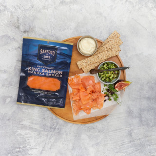 Sanford and Sons cold smoked salmon packet with salmon slices and grazing platter.